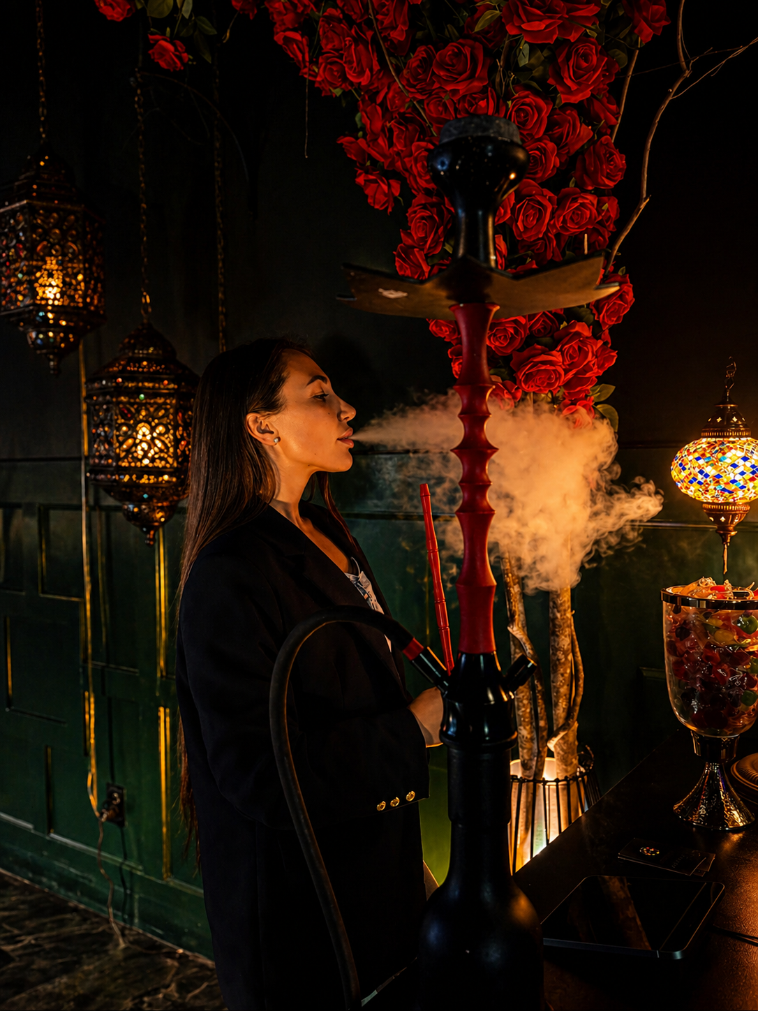 Guest enjoying hookah beneath red roses