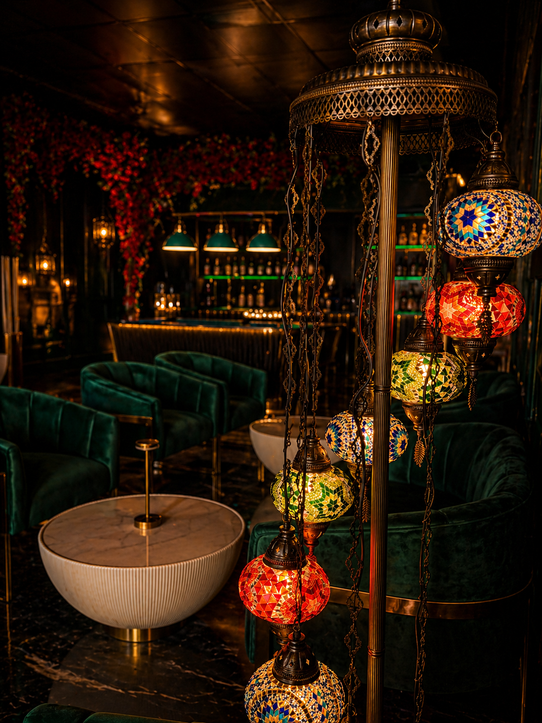 Inside NAAR — dim lounge with chandeliers and booth seating